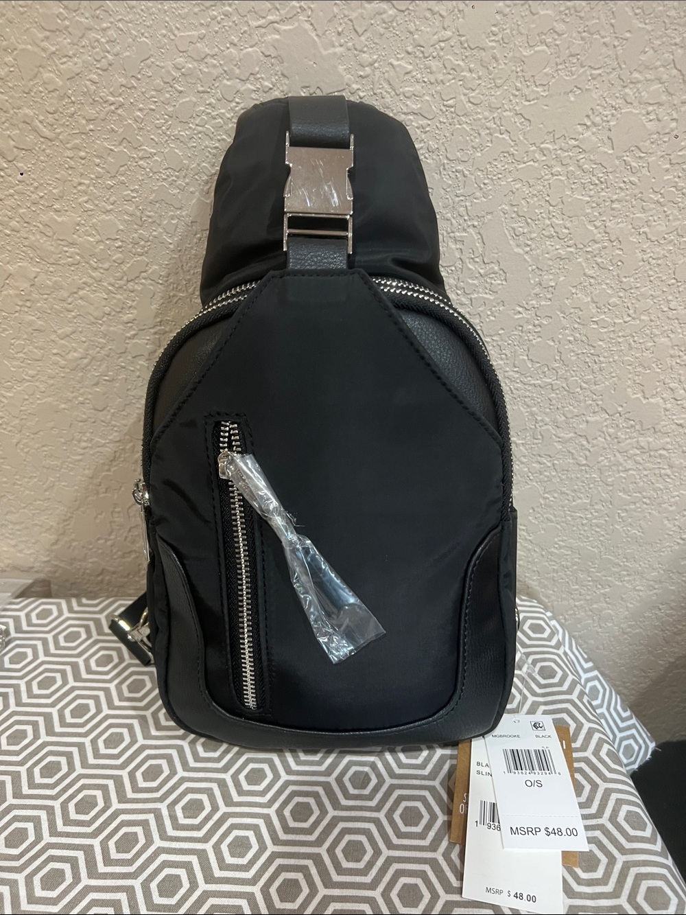 Madden girl black sling bag. Silver hardware
